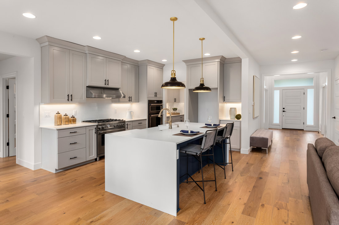 Under cabinet lighting, overhead lights, as well as pendant lights, transform this kitchen spacePicture